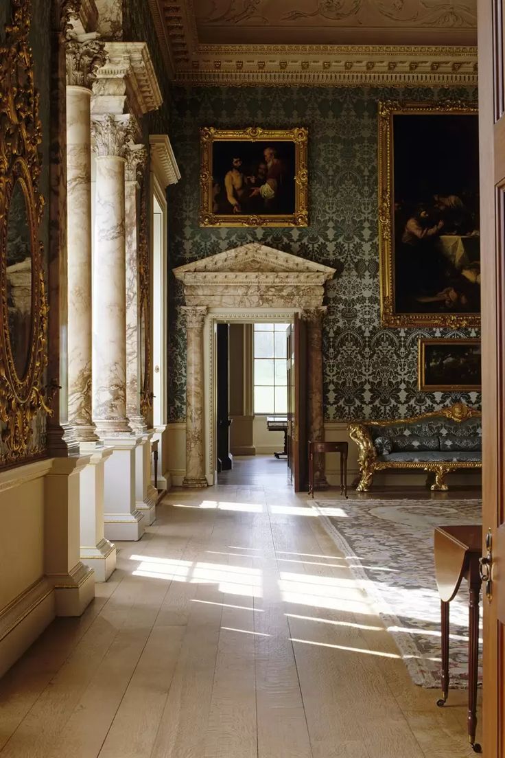 an ornate hallway with paintings on the walls