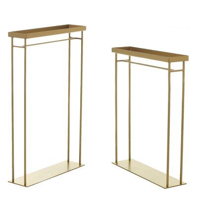 two gold metal and glass plant stands with shelves on each side, one holding a potted plant