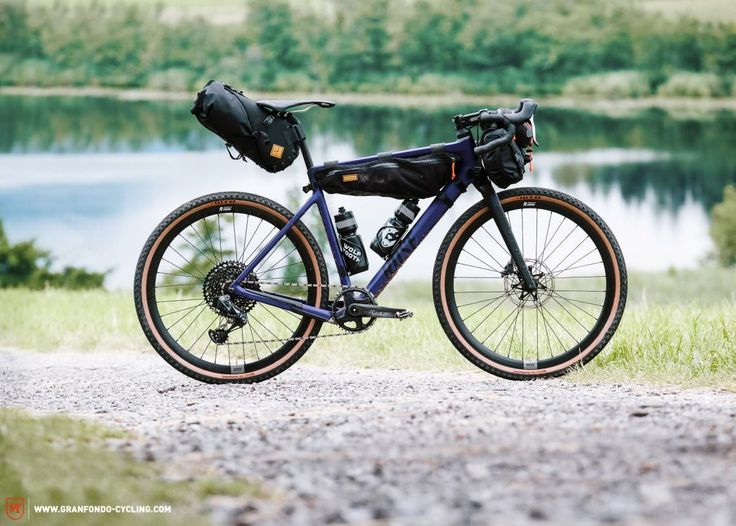 a bike parked on the side of a road next to a lake