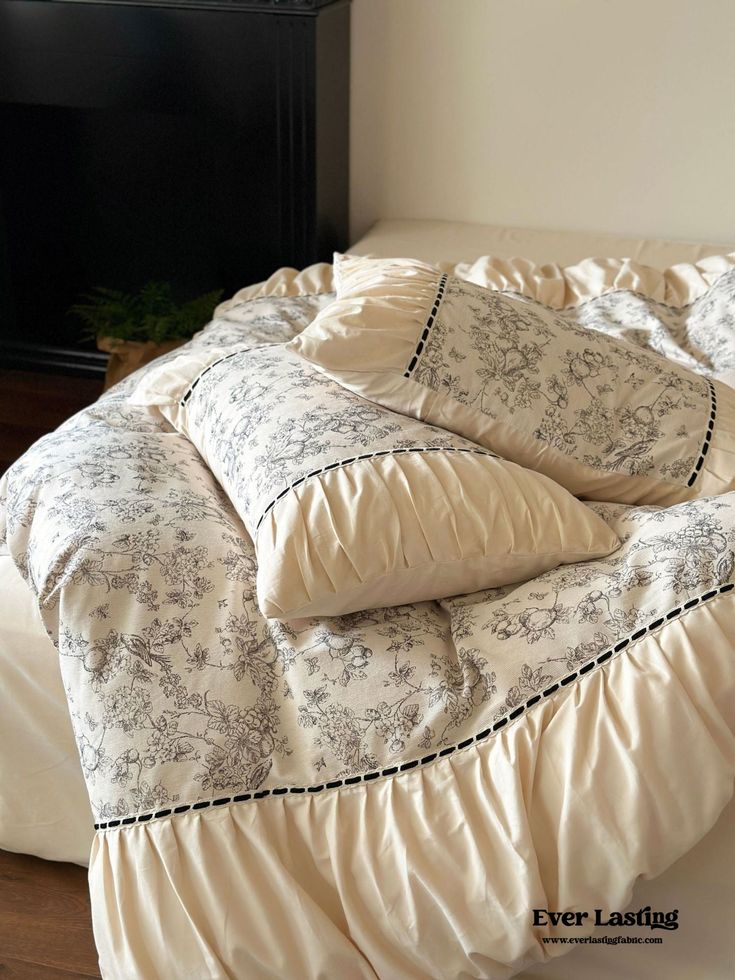 an unmade bed with four pillows on it