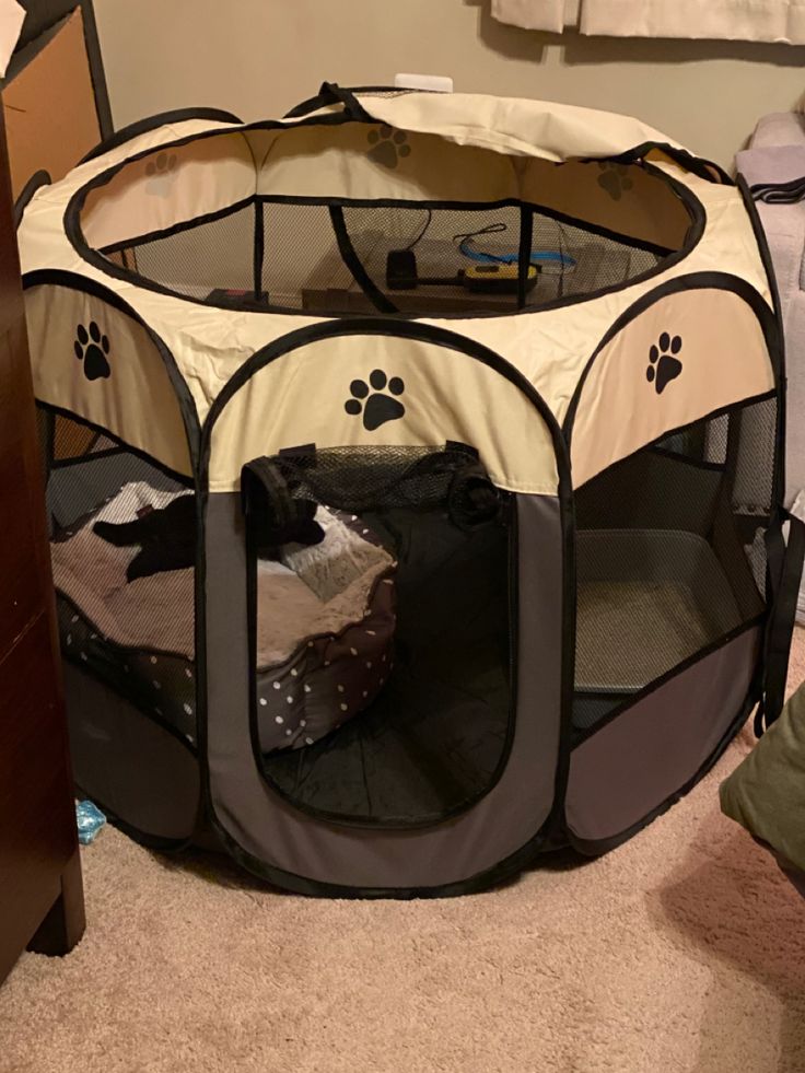 a dog's playpen is open and ready to be put into the house