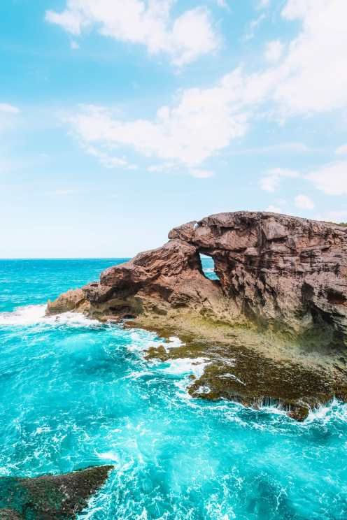 an ocean view with rocks and blue water