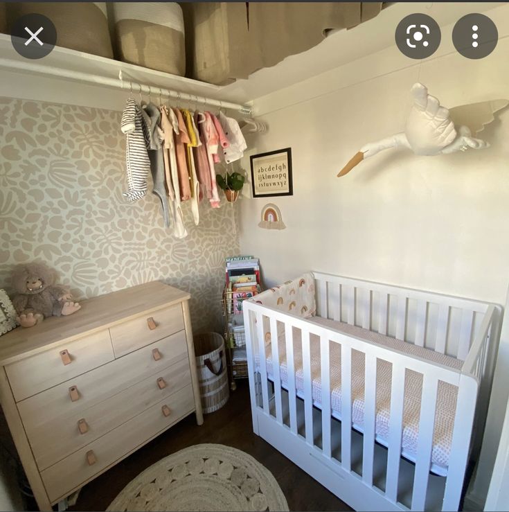 a baby's room with a crib and dresser