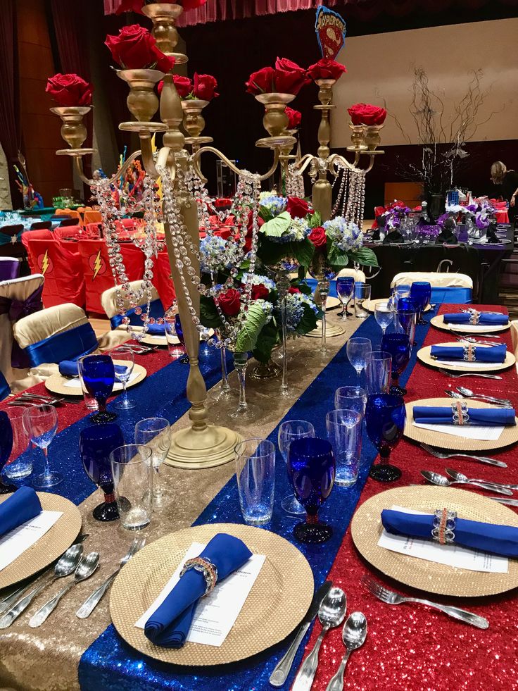 the table is set with red, white and blue place settings for an elegant dinner