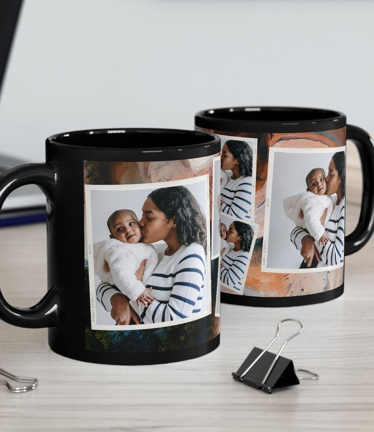 two black coffee mugs sitting on top of a table