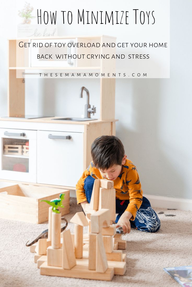 a young boy playing with wooden toys on the floor