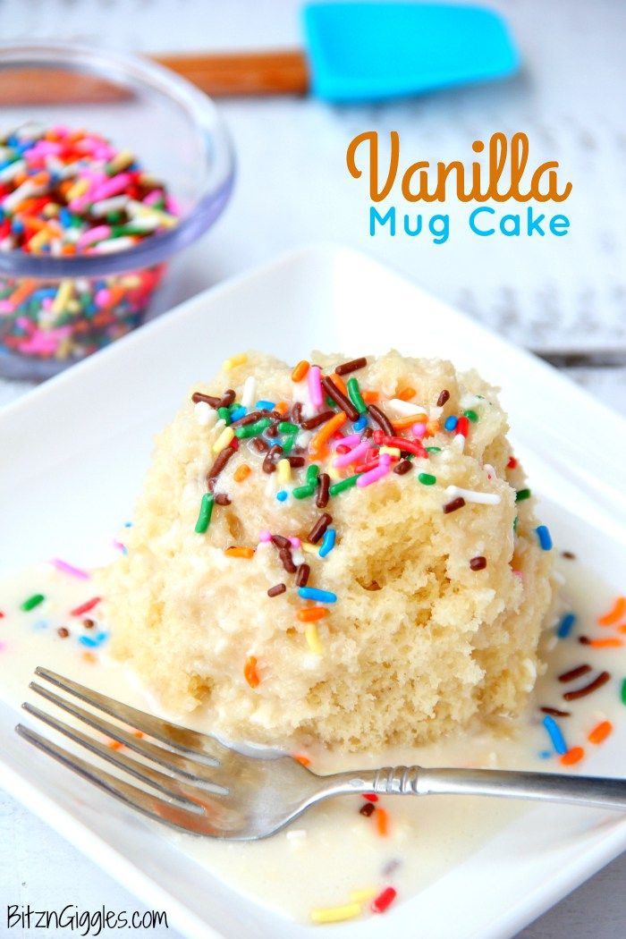 a piece of vanilla cake with sprinkles on a plate next to a fork