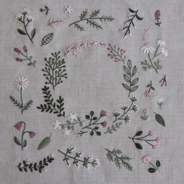 embroidered flowers and leaves are arranged in a circle