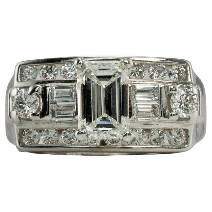 This gorgeous Vintage elegant ring is finely crafted in solid 14K White Gold and set with white and fiery genuine diamonds. The center emerald cut diamond is .50 carat. Four diamond baguettes .20 carats. Eighteen round brilliant cut diamonds total .44 carats. The diamonds are VS1 clarity and FG color for a grand total of (1.14cttw) The top of this genuine diamond ring measures 9mm North-South. The setting elevates 9mm high above the finger. This stylish ring is size 7.25 (can be resized) Total w Gold Band Diamond Ring, Gold Anniversary Bands, Estate Jewelry Rings, Statement Rings Diamond, Gold Diamond Band, Ringe Gold, Natural Diamond Ring, Emerald Cut Diamond, Stylish Rings