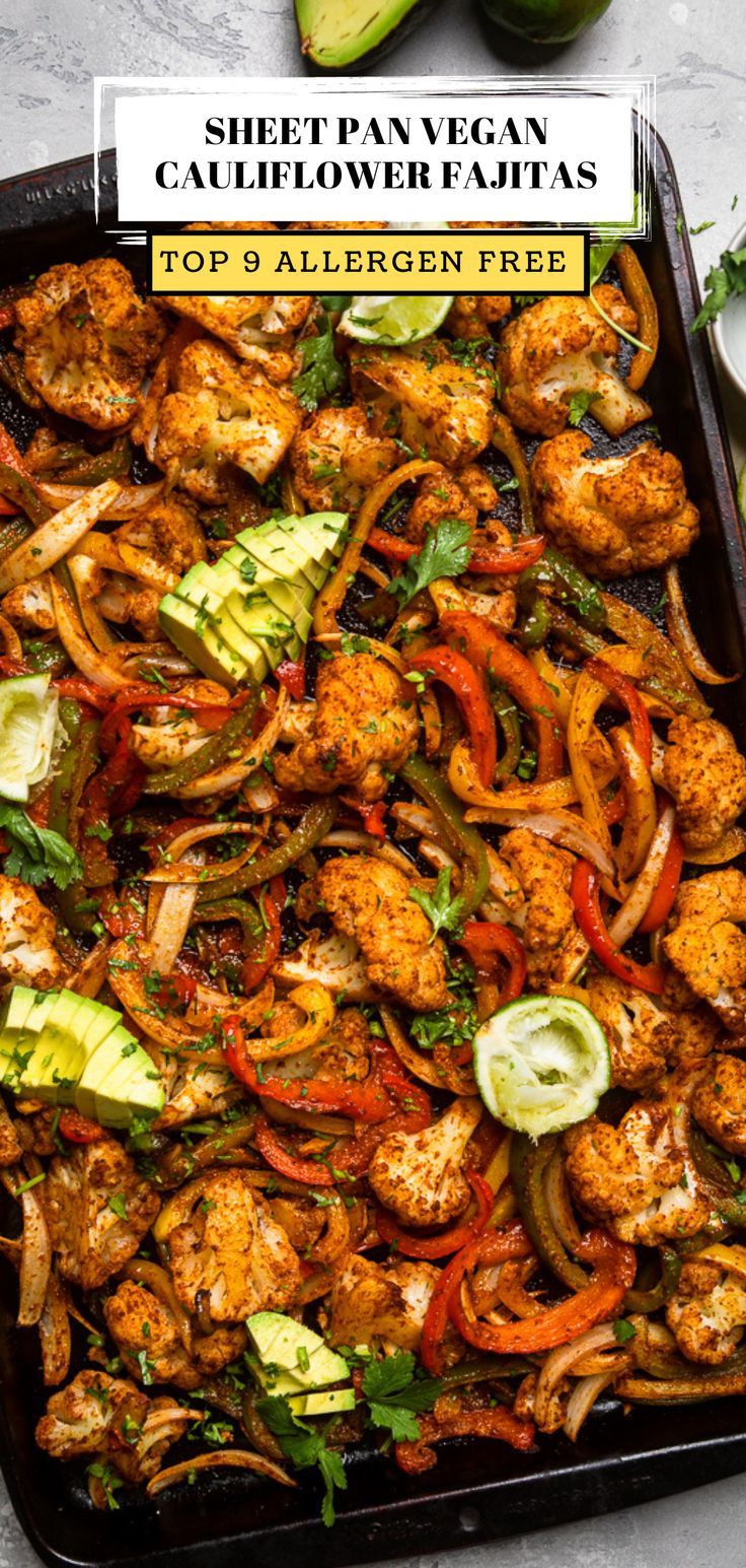 a sheet pan filled with chicken, peppers and avocado on top of a table