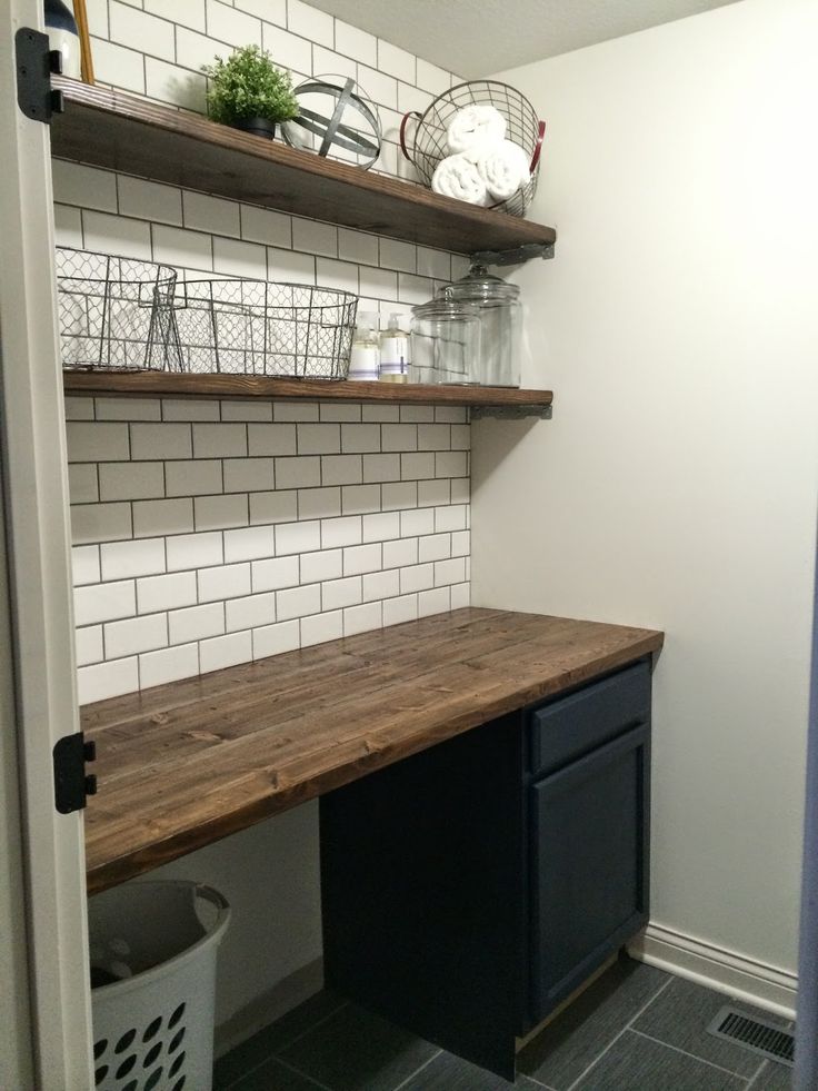 an empty laundry room with shelves on the wall