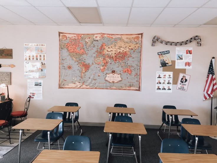 a classroom with desks, chairs and a map on the wall