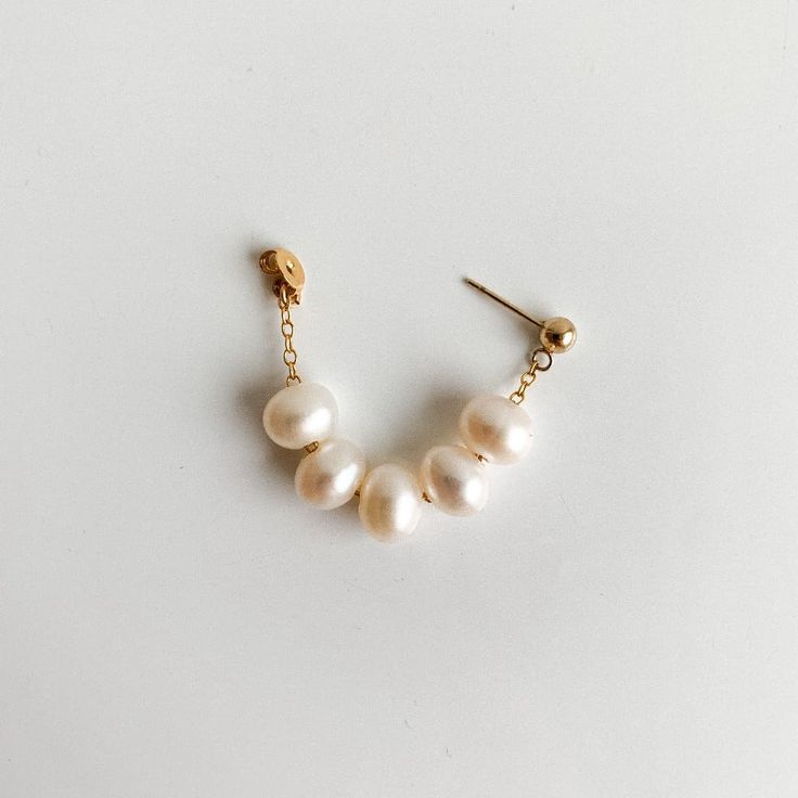 Discover the exquisite look of our Eilis Freshwater Pearl Wrap Around Earrings. Lustrous oval pearls in a contemporary wrap around style, drapes from front to back. This timeless accessory adds a touch of modernity to any ensemble. -- 14k Gold Filled pearls: 5x7mm Affordable Trendy Wrap Earrings For Gifts, Luxury Handmade Minimalist Jewelry, Gold Earring Wrap, Luxury Pearl Wedding Earrings With Ear Wire, Luxury Unique Wrap Earrings For Gifts, Cheap Elegant Adjustable Wrap Earrings, Cheap Handmade Elegant Wrap Earrings, Luxury Pearl Earrings With Ear Wire, Wire Wrapped Pearl Earring