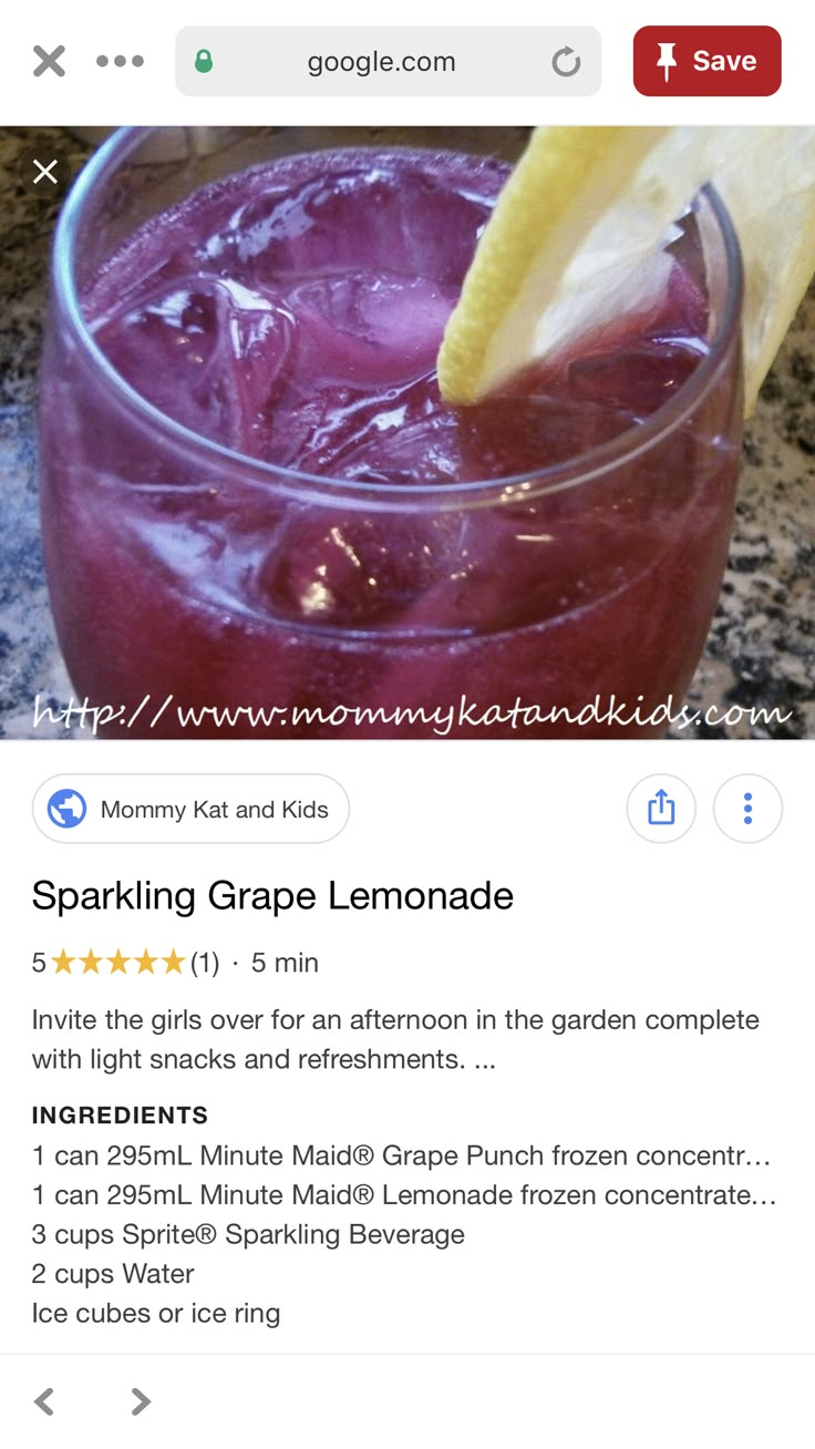 a glass filled with purple lemonade sitting on top of a counter