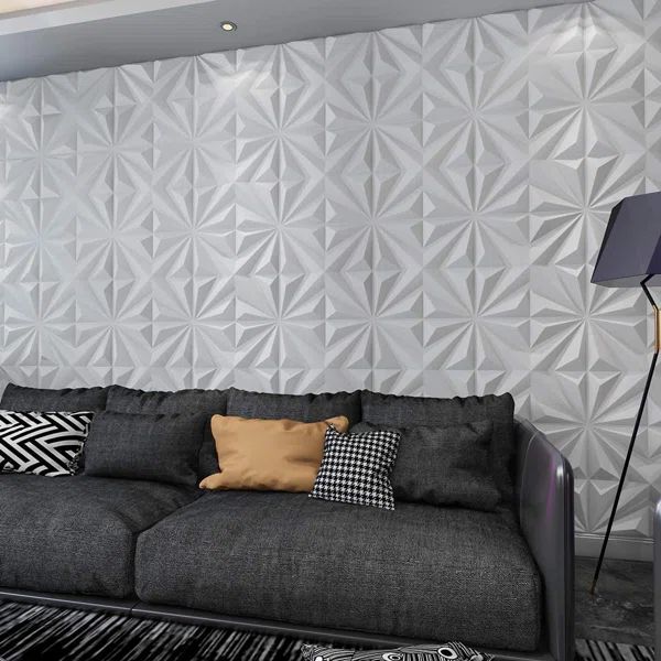 a black and white living room with geometric wallpaper