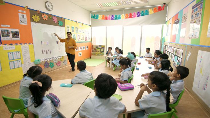 a teacher teaching children in a classroom