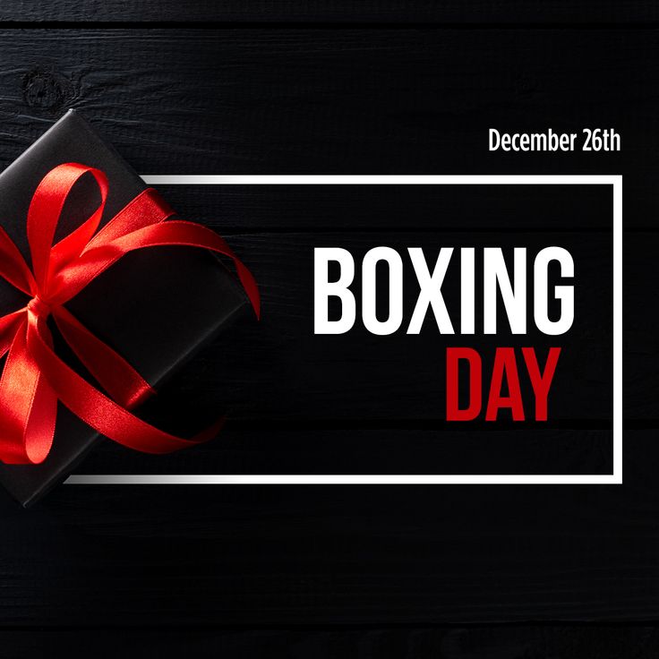 a black box with a red ribbon on it and the words boxing day written in white