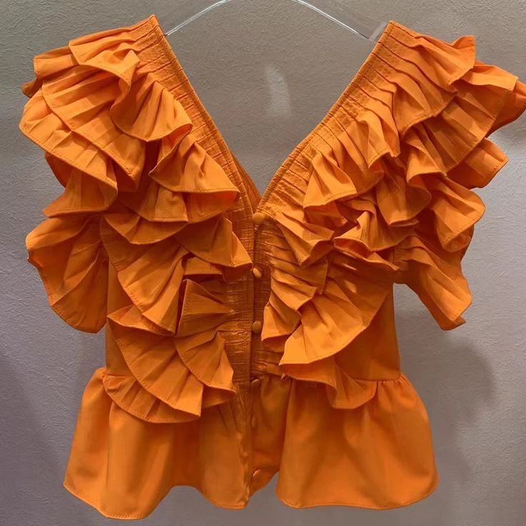 44487996113118|44487996145886|44487996178654 Sleeveless Ruffle Blouse, Solid Color Sleeveless Top With Ruffles, Sleeveless Solid Color Ruffled Top, Chic Orange Blouse With Ruffles, Sleeveless Ruffled Blouse, Solid Tops With Ruffles For Summer, Solid Color Ruffled Tops For Summer, Solid Ruffled Tops For Summer, Chic Orange Ruffled Blouse