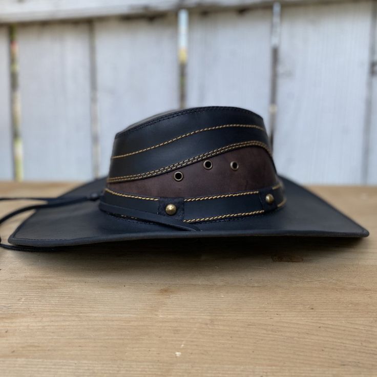 The price INCLUDES sales taxes and SHIPPING costs within the United States
This authentic leather hat, with its distinctive design and a star on the hat band, is a must-have accessory for a unique style. With a 3" brim and 4" crown, this black hat includes an adjustable drawstring for the perfect fit. Made 100% in Mexico, it is ideal for those looking for a quality leather hat with a touch of distinctive character.
Description of the Hat:
Because this hat is made of 100% genuine leather, the col Black Leather Hat, Leather Cowboy Hats, Leather Hat, Leather Hats, Black Hat, Hat Band, Sales Tax, Character Description, Cowboy Hat