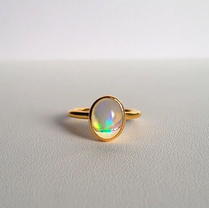 Natural Opal Ring-Fire Opal Ring-Oval Opal Ring-Dainty Opal Ring-Stackable Ring-Sterling Silver Ring-14k Solid Gold Ring-October birthstone ABOUT RING Gemstone - Natural Ethiopian Opal Gemstone shape - Oval (Cabochon) Gemstone Size - 6x8mm   ------------------------------------------------------------------------------------------------------------------------------------------------- Fast Shipping: It will take 1-8 business days to send out your item Material: 22k/20k/18k/14k/10k/9k Yellow Gold Minimalist Oval Cabochon Opal Ring For Anniversary, Oval Gemstone Gold Stackable Rings, Oval Opal Stackable Rings As Gift, Minimalist Oval Opal Ring For Anniversary, Dainty Oval Opal Ring For Anniversary, Oval 14k Gold Opal Ring, Oval Solitaire Moonstone Ring In 14k Gold, Dainty Oval Halo Rings, Minimalist Oval May Birthstone Rings