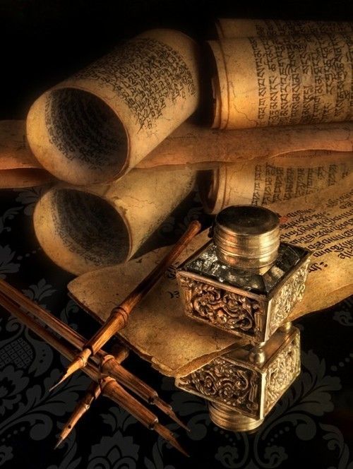 an old book, inkwell and pen on a table with other writing materials in black and white