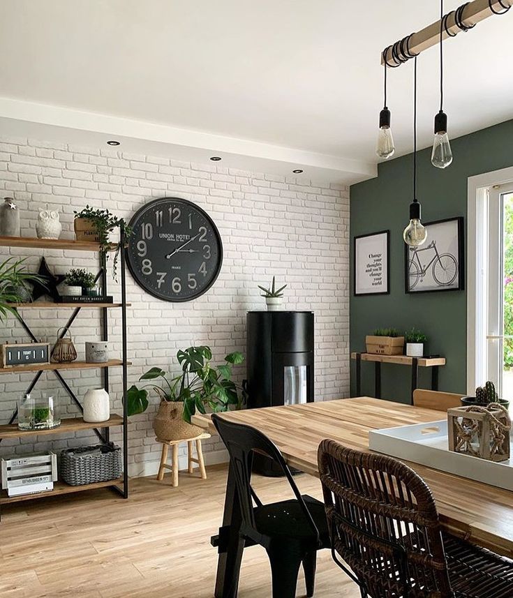 a dining room table with chairs and a clock on the wall