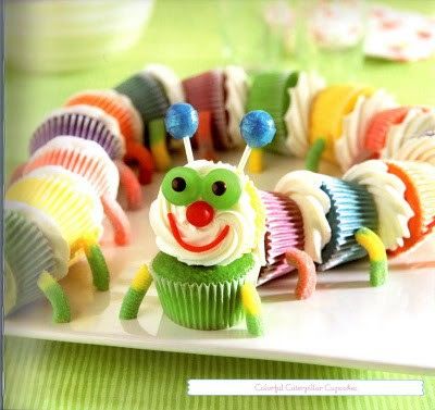 cupcakes decorated with colorful icing and clown faces are displayed on a plate