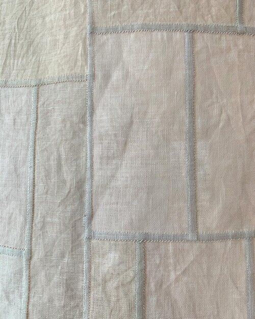 a close up view of a white and blue quilt