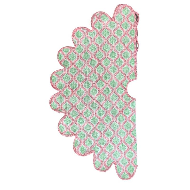 a pink and green patterned paper on a white background, with an intricate design in the center