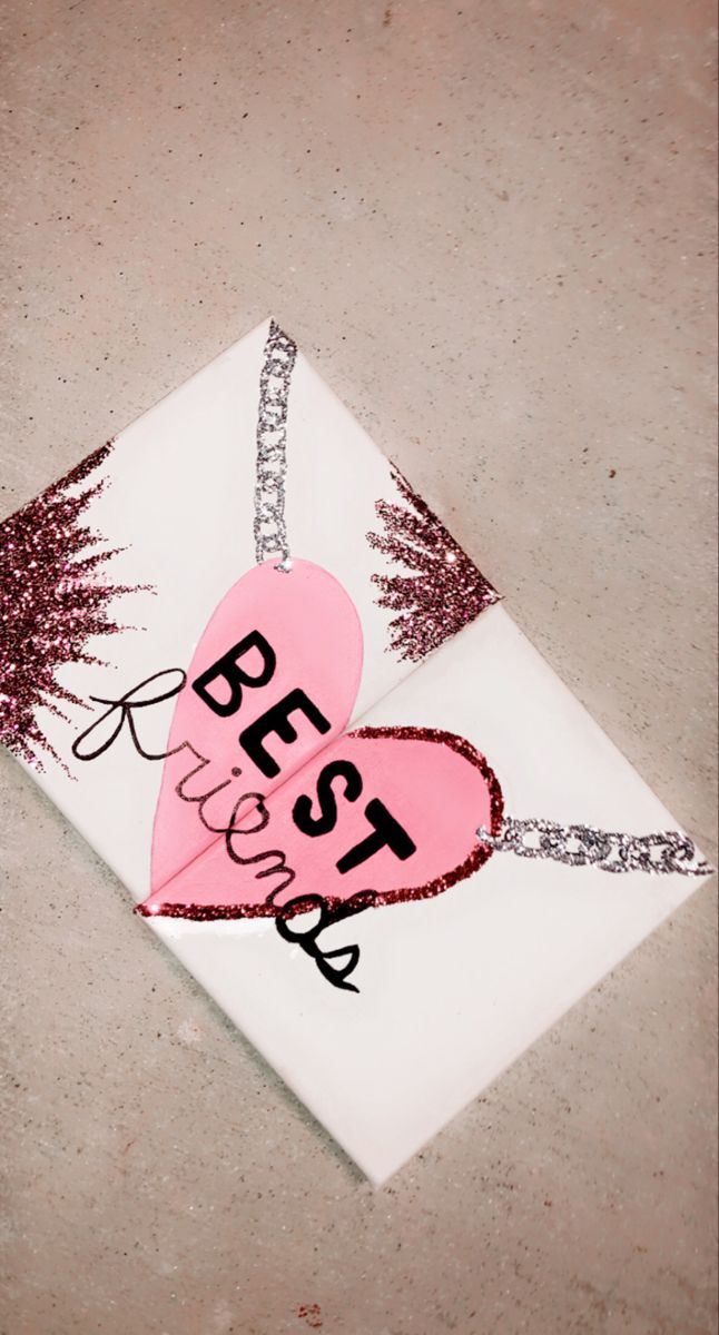 two paper hearts on top of a white envelope with the words best sister written on it