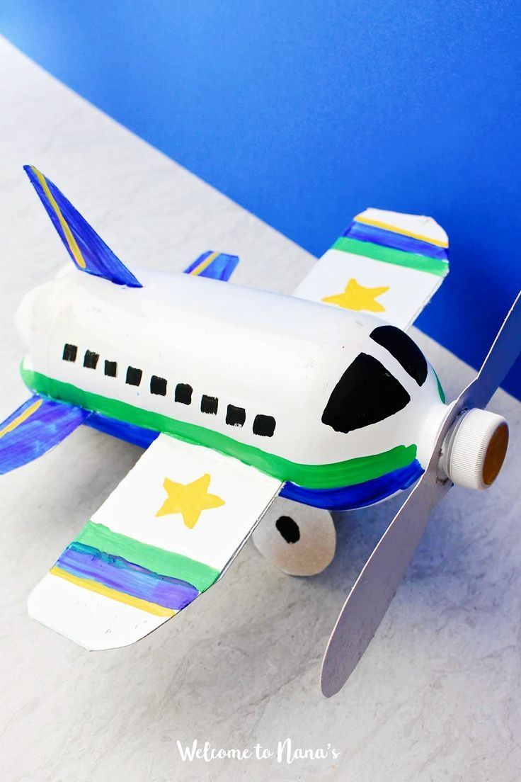 a toy airplane sitting on top of a white table next to a blue wall and floor