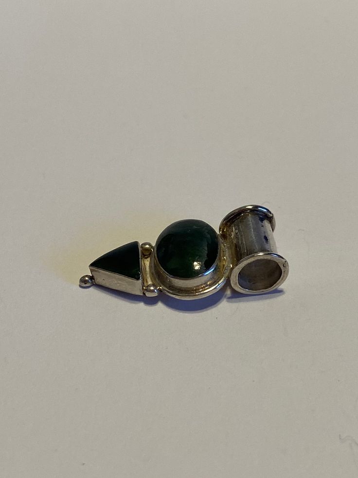 "This is a gorgeous, vintage, handmade Navajo green jade and 950 sterling silver geometric pendant. The piece measures about 1 1/4\" by 3/4\" by 3/16\". The bale opening is about 3/8\". The stones are set in polished sterling silver bezels and are vibrant. The oval-cut stone measures about 5/8\" by 3/8\" while the triangular-cut stone measures about 3/8\" by 3/8\". The piece weighs about 3.6 grams and is stamped 950. The 950 sterling silver is 95% silver compared to 925 sterling silver which is Artisan Silver Jade Jewelry, Unique Green Engraved Jewelry, Native American Vintage, Sterling Pendant, Geometric Pendant, Boho Gifts, Pendant Silver, Green Jade, Jade Green