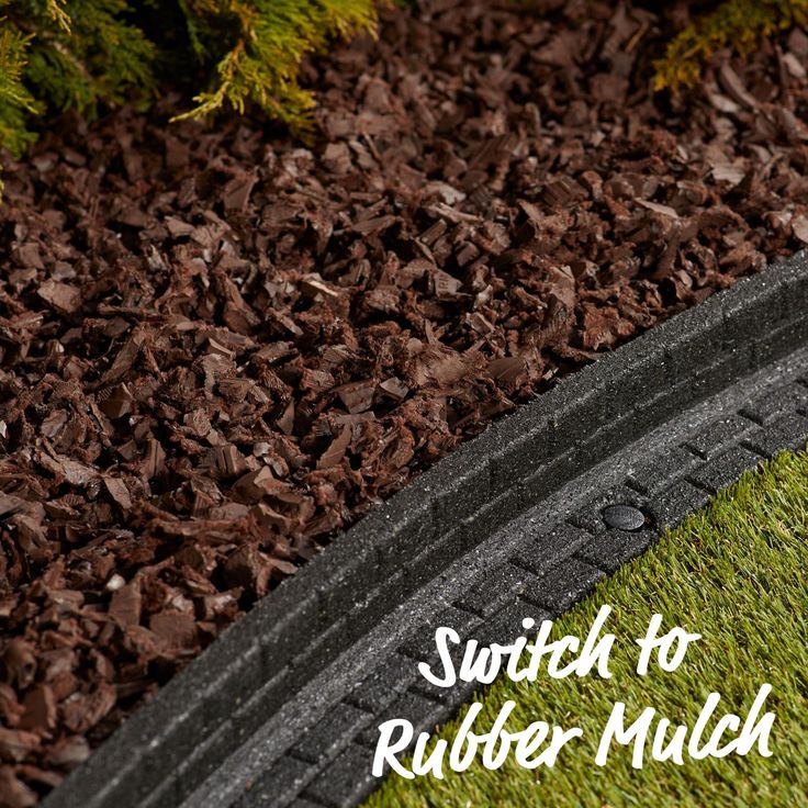 a close up of a tire on the ground with grass and mulch around it