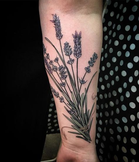 a woman's arm with lavender flowers on it