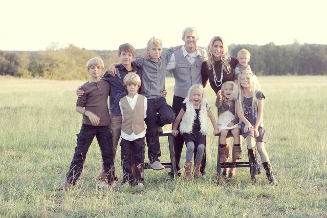 a group of people standing next to each other in a field