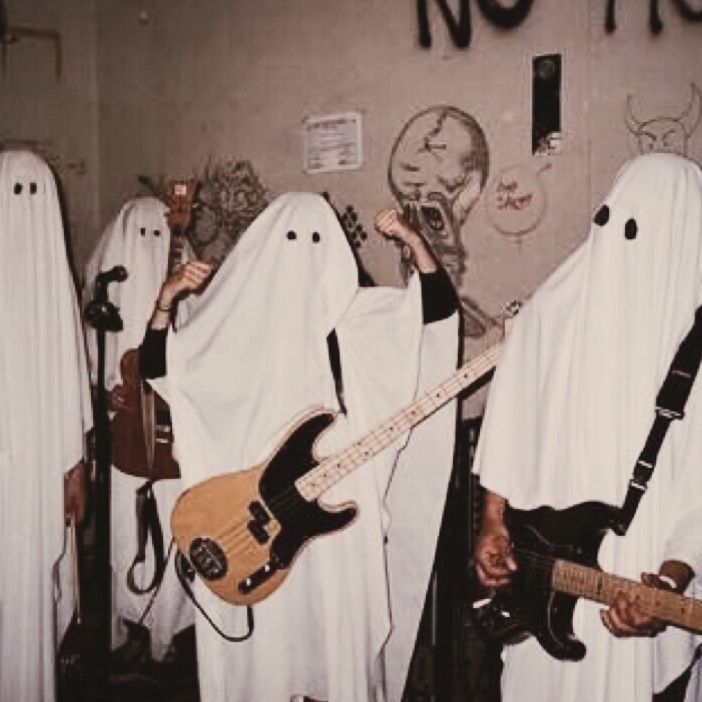 two men dressed as ghost playing guitars and singing