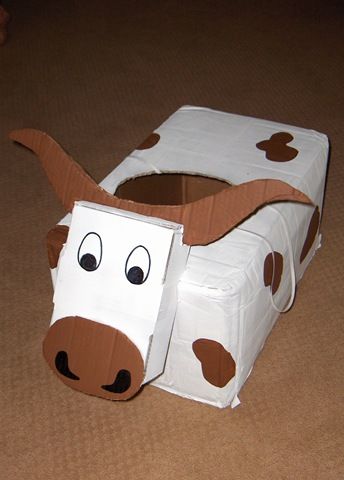 a cardboard cow is sitting on the floor