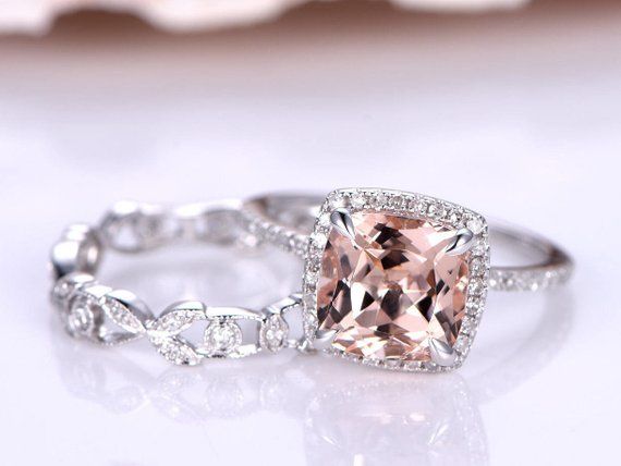 an engagement ring with a cushion cut peach morganite surrounded by white gold and diamonds