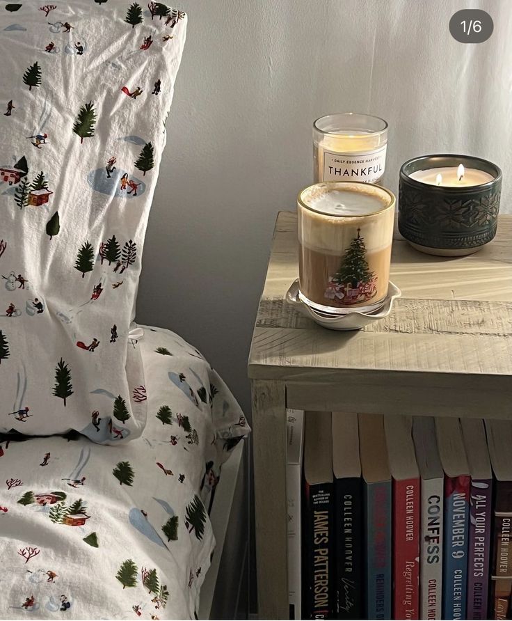 there is a candle and some books on the table next to the bed in this room