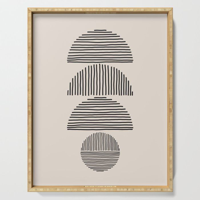 a black and white print on a beige wall above a wooden frame with an abstract design