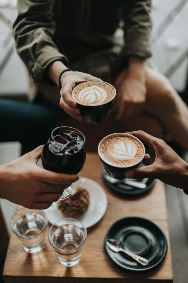 three people toasting with drinks on top of a table in front of the words 8 reasons why you should eat breakfast