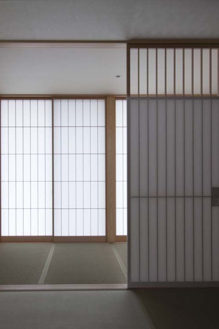 an empty room with sliding doors and white walls