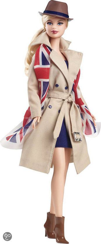 a barbie doll dressed in a british flag outfit and trench coat, standing on a white background