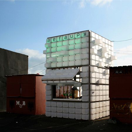 a building made out of plastic bottles and containers