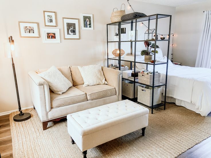 a living room filled with furniture and pictures hanging on the wall above it's bed