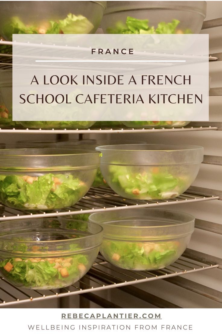 some food is sitting in bowls on the shelf next to each other and there is a sign that says, a look inside a french school cafeteria kitchen