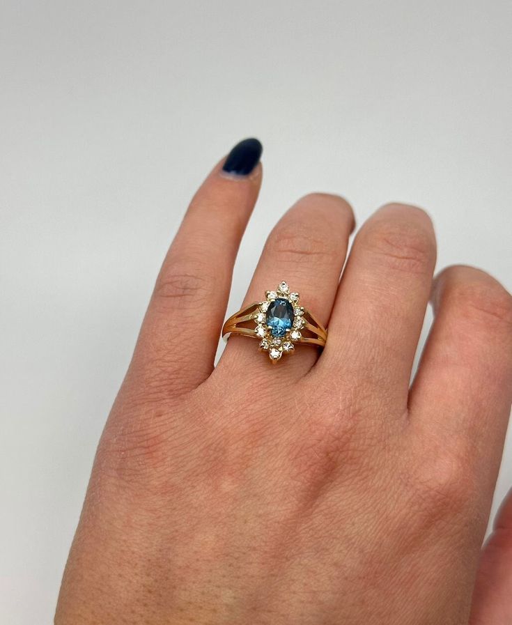 This estate ring has all that vintage flair, but in the condition of a brand new ring! An oval London Blue Topaz is adorned by 0.33 carats total worth of diamonds. This ring would make for the most stunning untraditional engagement ring! The piece is a size 6. Vintage Yellow Gold Rings With Blue Topaz, Antique Yellow Gold Hallmarked Topaz Ring, Antique Blue Topaz Ring Hallmarked, Vintage Yellow Gold Topaz Ring, Hallmarked, Blue Topaz Multi-stone Ring In 14k Gold, Estate Rings, London Blue, London Blue Topaz, Blue Topaz