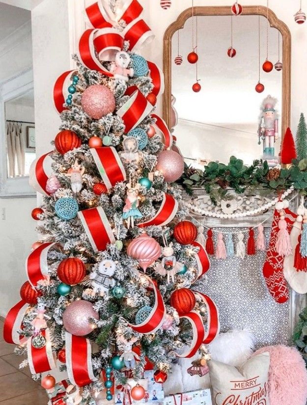 a christmas tree decorated with red, white and blue ornaments in front of a mirror