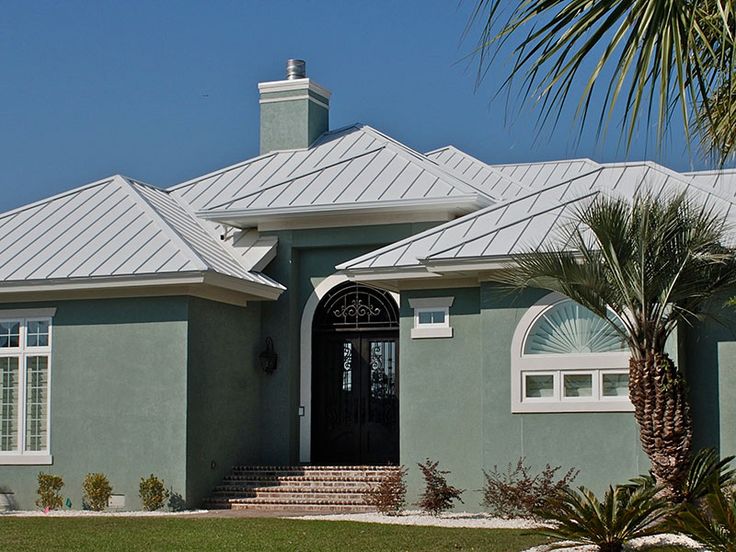 a house with a palm tree in front of it