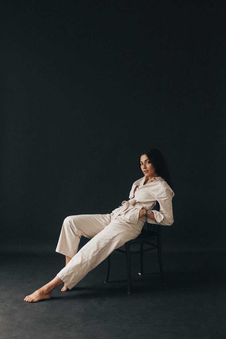 a woman sitting in a chair with her legs crossed